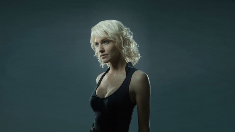 Tricia Helfer, Battlestar Galactica, blonde, simple background, black tops, Number 6, cleavage, tight clothing, women, blue eyes, 1080P, model, actress