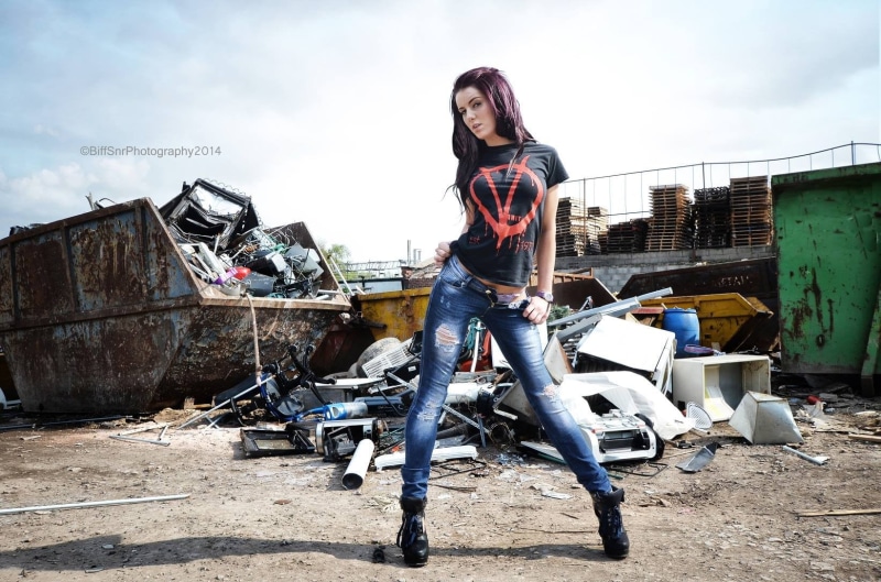 red, one person, casual clothing, trash, sitting, young women, beautiful woman, women, cloud - sky, shirt, young adult, crew, sky, looking at camera, urban