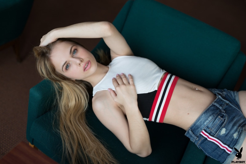 jean shorts, pierced navel, lips, navel, short shorts, armpit, face, lying on back, 2K, tank top, couch, looking at viewer, Playboy, belly, photo, model