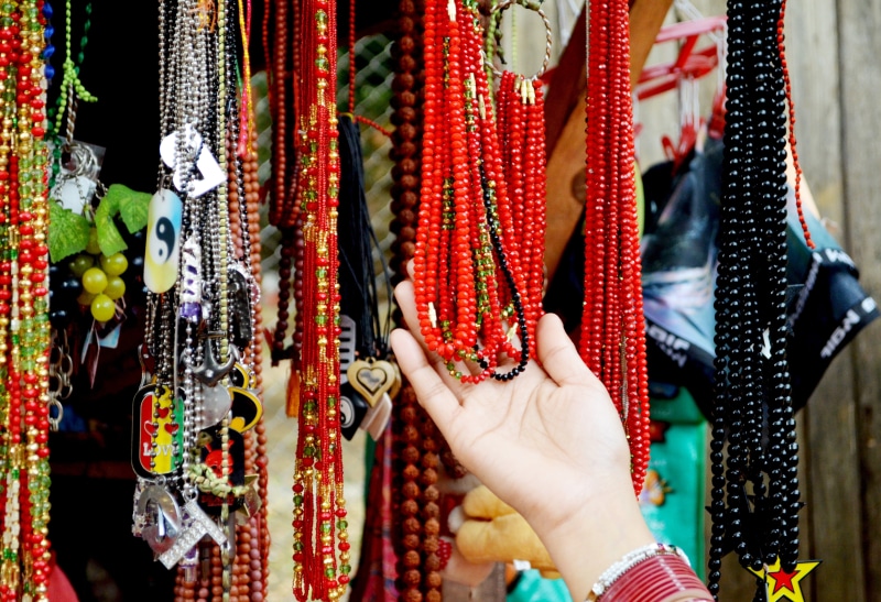 for sale, beaded, bracelet, beads, clothing, business, holding, hanging, market, 4K, necklace, fashion, human body part, worship, person, focus on foreground