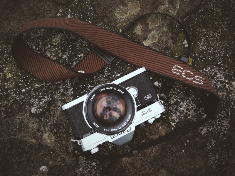 camera - Photographic Equipment, retro Styled, day, strap, Canon EOS, directly above, manual camera, vintage camera, single Object, still life, abandoned