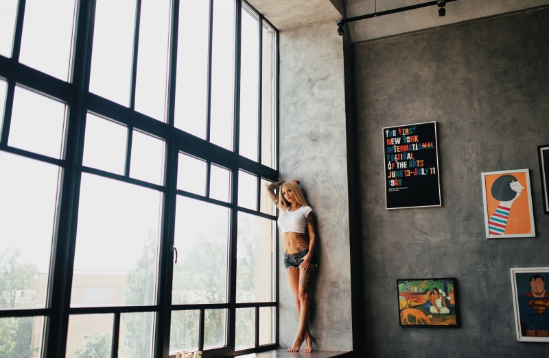 glass - material, art and craft, casual clothing, window, pierced navel, day, representation, wall - building feature, home interior, real people, tattoo