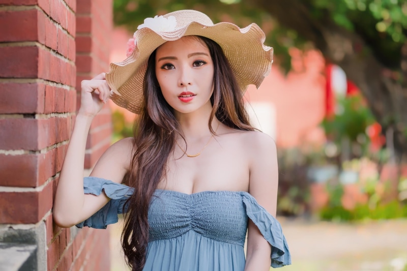 brunette, clothing, sun hat, day, leisure activity, young women, women, depth of field, beauty, women outdoors, brick, long hair, one person, fashion, hairstyle