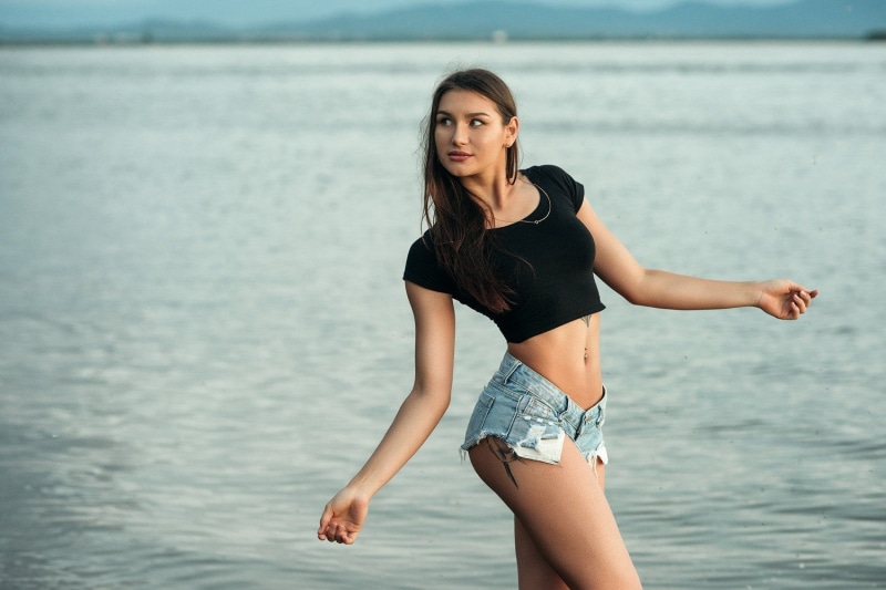 beach, sea, young women, beautiful woman, leisure activity, land, water, lifestyles, hairstyle, one person, focus on foreground, pierced navel, fashion