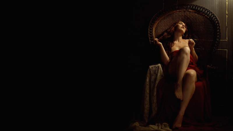 pose, long-haired, fabric, sitting, darkness, brown hair, hands, chair, face, 2K, girl, feet, mood, black background