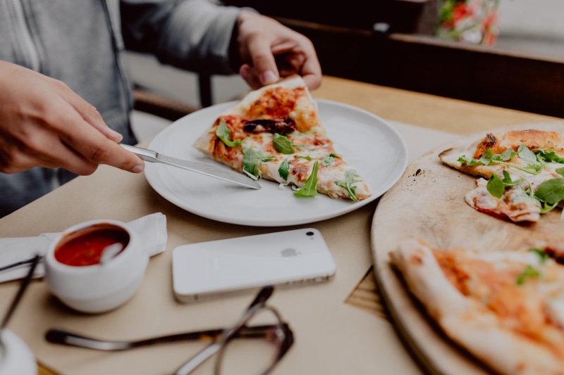 delicious, human hand, indoors, plate, food, italian, meal, restaurant, midsection, human body part, table, hungry, ready-to-eat, holding, cheese, eat
