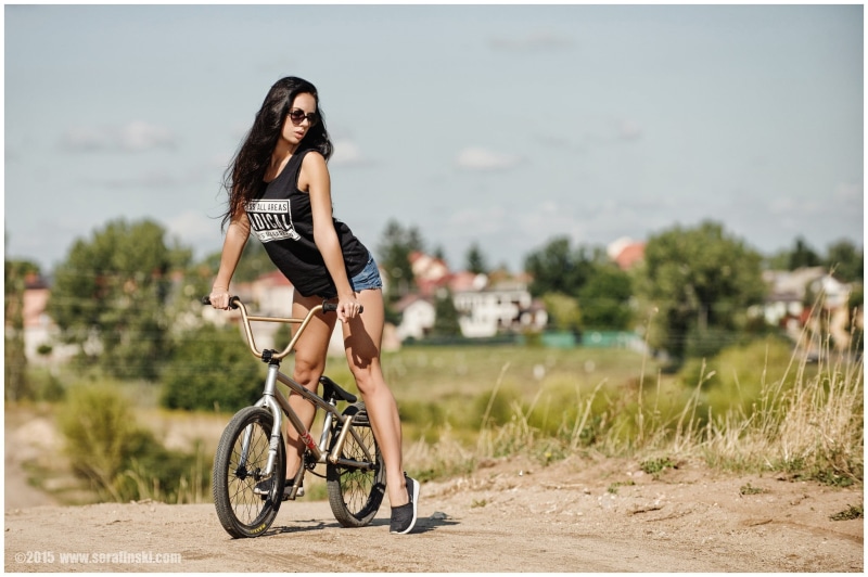leisure activity, women outdoors, hair, nature, hairstyle, real people, bicycle, neck, jean shorts, beautiful woman, scoop, outdoors, transportation, T-shirt