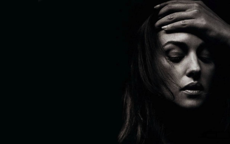 belucci, distraught, black background, beautiful woman, negative emotion, depression - sadness, hopelessness, human face, human body part, emotion, pain