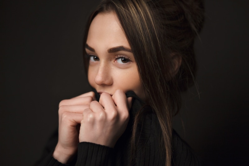 face, 1080P, black sweater, serious, human body part, young adult, Olga Katysheva, human face, long hair, studio shot, indoors, one person, hand, simple background