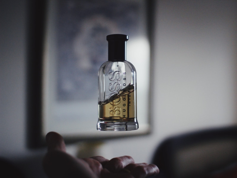 fragrance, person, bottle, wine bottle, glass - material, boss, men, body part, perfume, alcohol, shallow, hugo, hugo boss, top, s, real people, indoors
