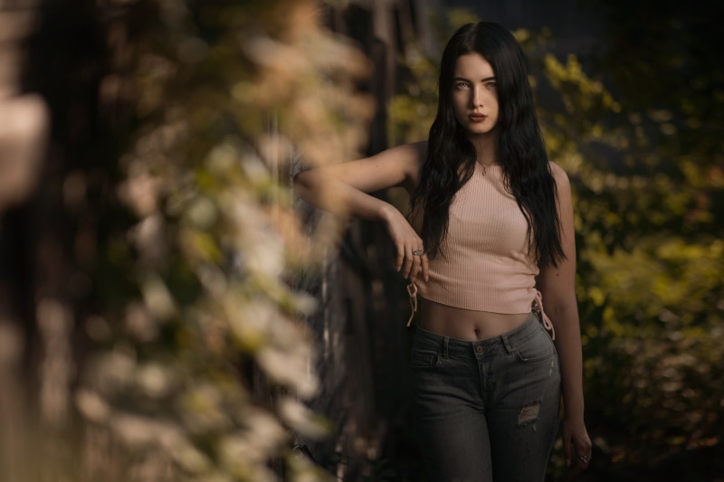 one person, outdoors, long hair, adult, young adult, casual clothing, 720P, plant, belly, hair, fashion, jeans, portrait, teenager, beautiful woman, hairstyle