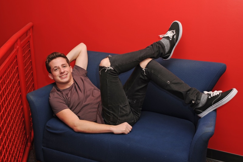charlie puth, happiness, looking at camera, smiling, fashion, indoors, hands behind head, furniture, adult, hd, domestic room, sofa, 4k, lying down, young men