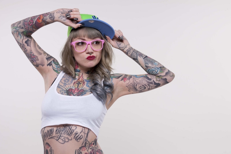 young women, human arm, young adult, studio shot, 2K, sunglasses, beautiful woman, three quarter length, front view, hand, dyed hair, arms raised, hat