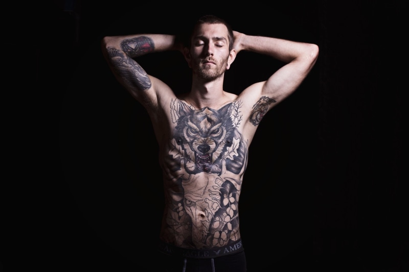 hand, waist up, Tattoo, one person, studio shot, Man, standing, clothing, front view, three quarter length, arms raised, indoors, young adult, Artistic