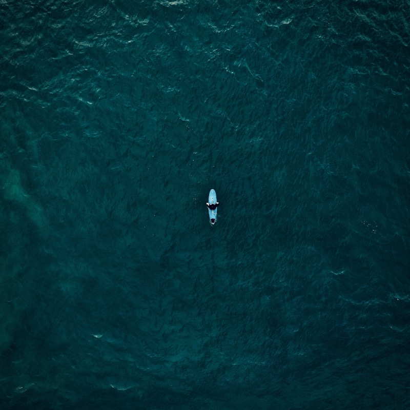 high angle view, lifestyles, nautical vessel, top view, water, waterfront, one person, nature, day, surfing, beauty in nature, white, tranquility, leisure activity