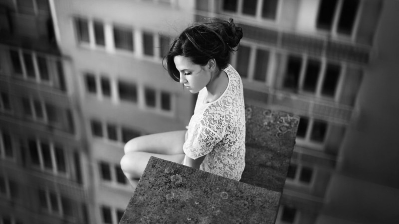 day, young adult, outdoors, window, built structure, brunette, leisure activity, beautiful woman, contemplation, selective focus, sitting, standing, looking