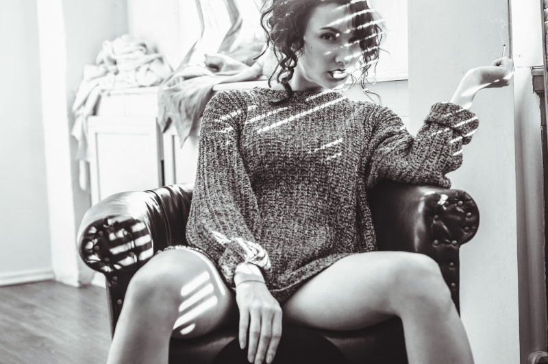 suggestive, young women, smoking, lifestyles, leisure activity, sweater, wool, fashion, hairstyle, monochrome, legs, women, looking at viewer, curly hair