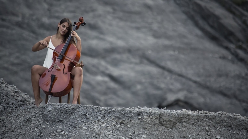 performance, brunette, string instrument, outdoors, cello, spread legs, cellist, clothing, nature, adult, playing, model, beautiful woman, chair, music