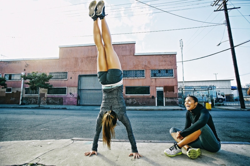 casual clothing, young women, young men, building exterior, women, 1080P, handstand, exercising, architecture, sport, people, togetherness, young adult