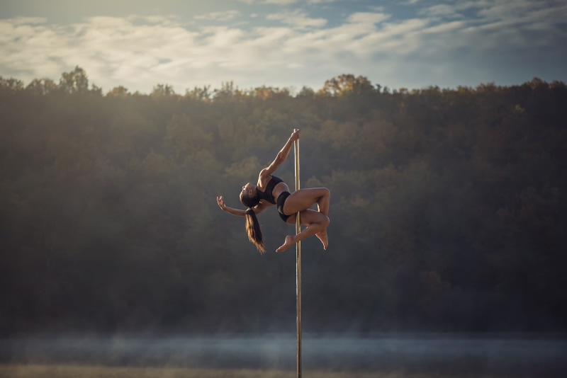 healthy lifestyle, acrobat, strength, sport, pole, outdoors, vitality, gymnastics, one person, real people, exercising, sky, flexibility, nature, handstand