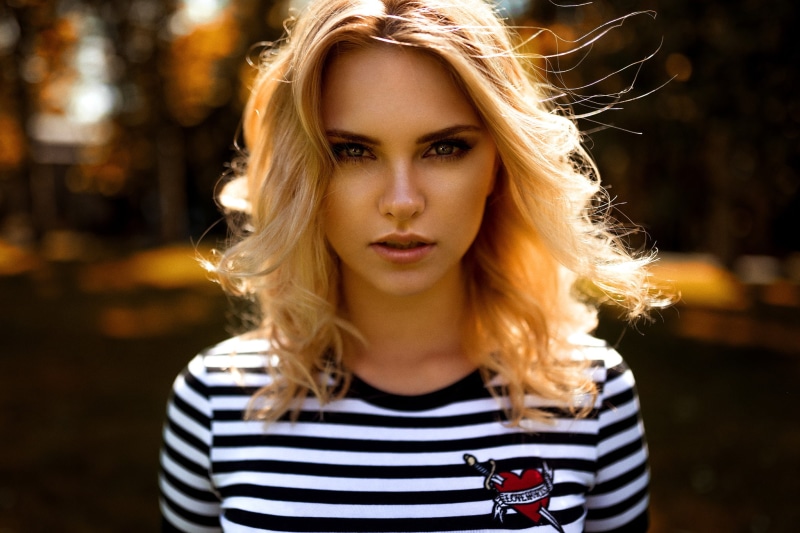 beautiful woman, portrait, headshot, outdoors, human hair, hair, young women, blonde, beauty, front view, striped, focus on foreground, top - garment, adult