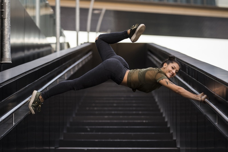 1080P, sports clothing, flexibility, steps and staircases, looking at viewer, human arm, clothing, one person, railing, healthy lifestyle, model, side view
