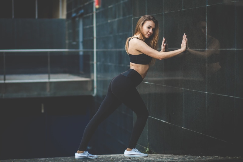 sports clothing, women, brunette, arched back, blonde, women outdoors, sneakers, real people, adult, full length, built structure, exercising, wall - building feature
