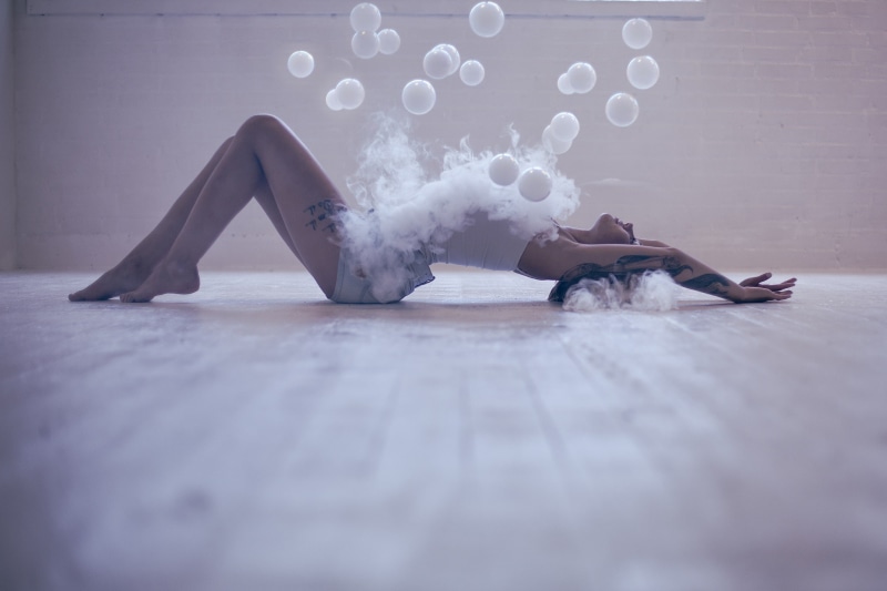 human arm, Denice Nielsen, arms up, jean shorts, real people, day, selective focus, front view, lifestyles, lying down, surface level, sitting, smoke, women