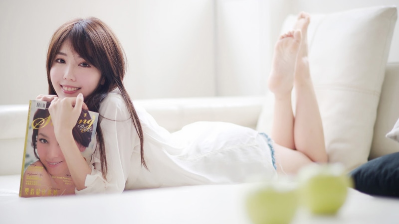 sitting, people, hair, brown hair, domestic life, living room, in bed, lying on front, adult, women, barefoot, furniture, casual clothing, relaxation, brunette