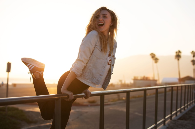young adult, emotion, leisure activity, road, peyton, leggings, sneakers, building, laughing, open mouth, one person, positive emotion, actress, sunlight