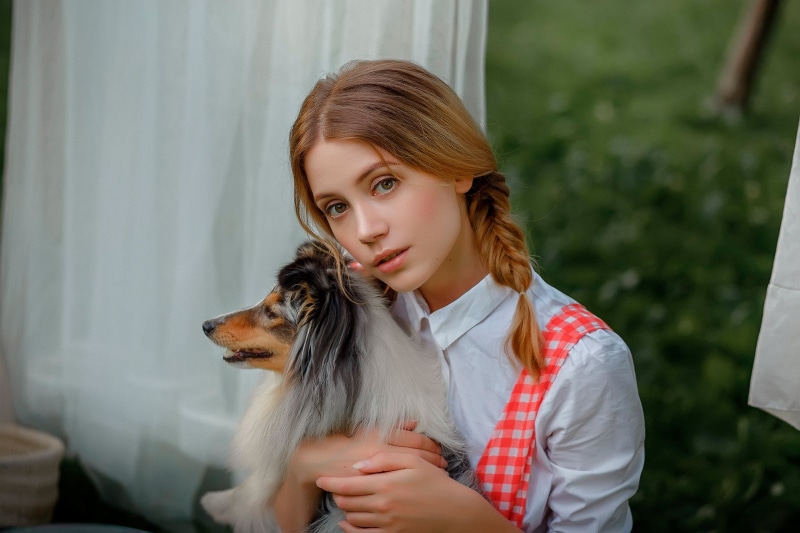 hairstyle, hair, dog, white dress, beautiful woman, one person, young adult, leisure activity, real people, pet owner, one animal, domestic, white clothing
