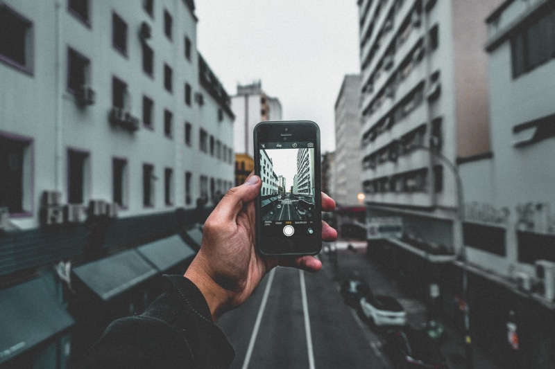 one person, building, wireless technology, portable information device, built structure, architecture, photographing, iphone, camera - photographic equipment