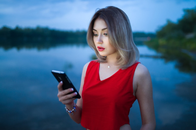 looking, water, young adult, portrait, wireless technology, hairstyle, focus on foreground, hair, red, red lipstick, one person, fashion, standing, communication