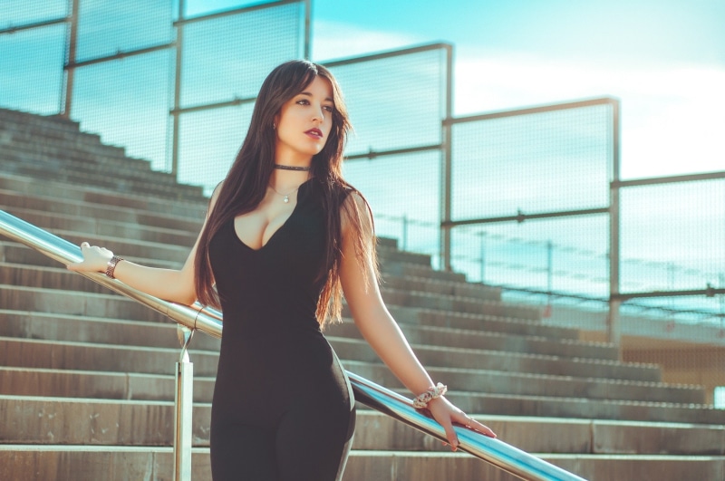 cleavage, Gina Blanch, looking into the distance, women, black clothing, tight clothing, looking away, portrait, brunette, jumpsuit, women outdoors, stairs