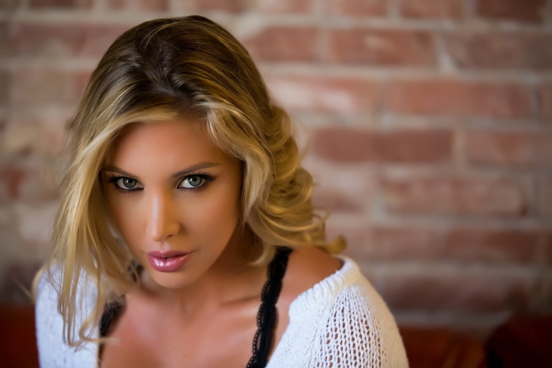 human hair, hair, brick wall, front view, one person, blonde, model, young women, close-up, eyes, sweater, headshot, Samantha Saint, s, wall, makeup, lips