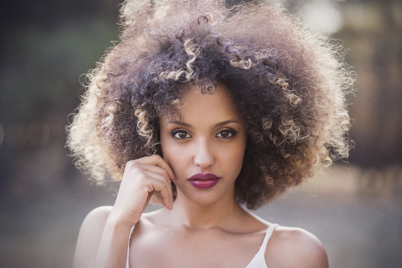 serious, looking at camera, focus on foreground, women, 1080P, beautiful woman, headshot, outdoors, looking at viewer, face, frizzy, close-up, hair, front view