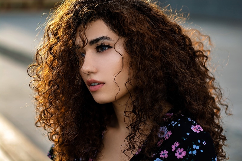 brown hair, front view, one person, frizzy, beauty, curly hair, model, portrait, fashion, adult, looking, 2K, outdoors, human hair, headshot, face, young adult
