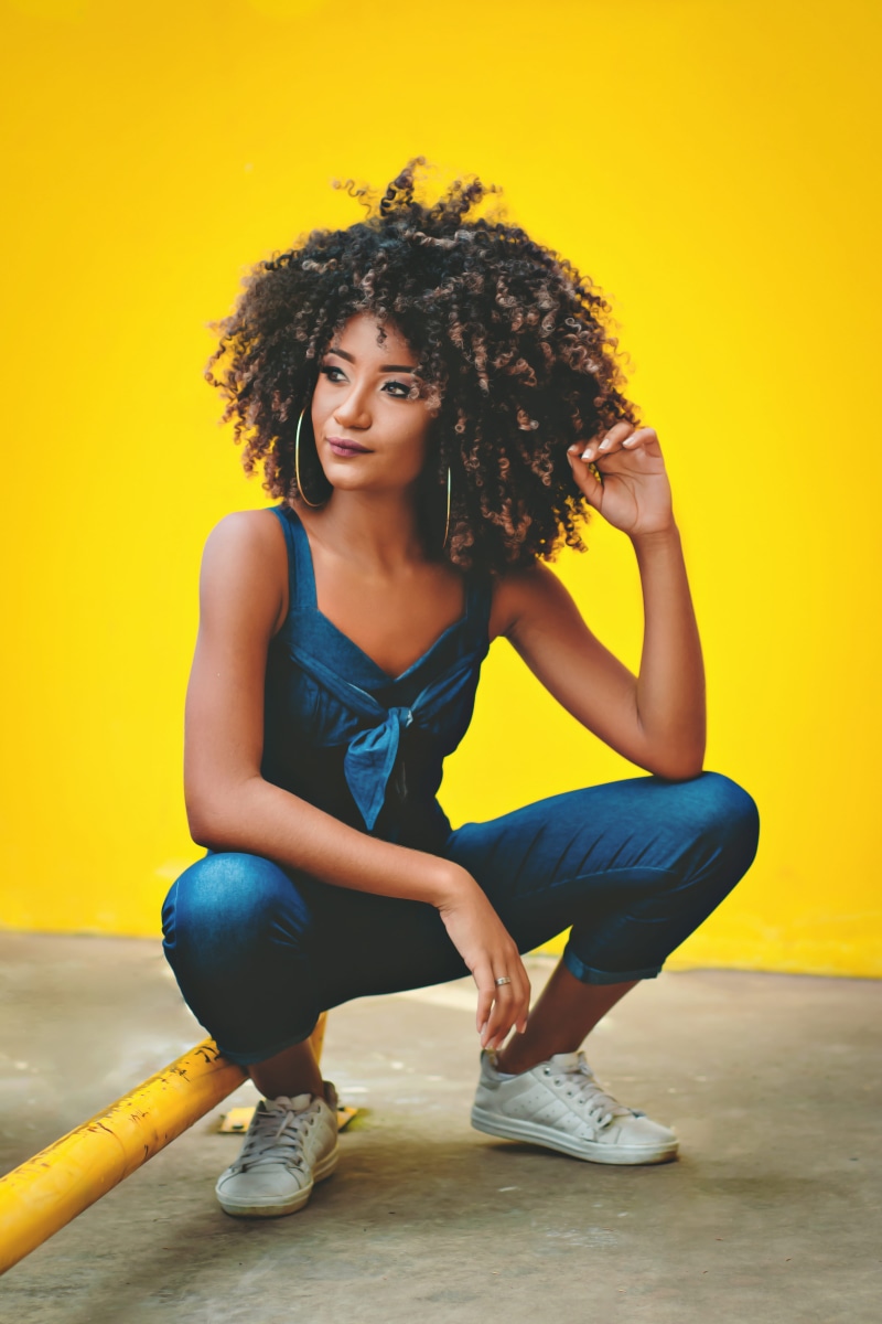 looking away, full length, hair, casual clothing, real people, hairstyle, squat, curly hair, wall, young women, indoors, 5K, young adult, sitting, yellow