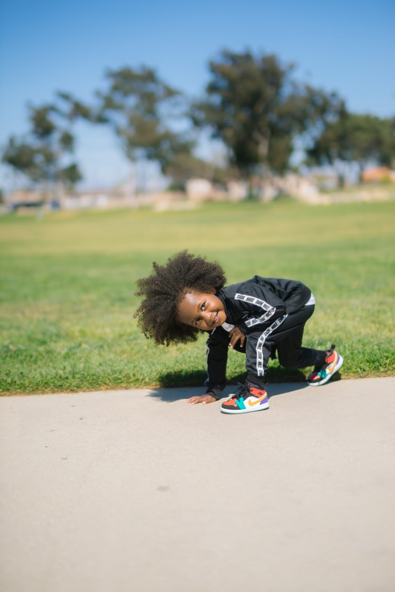curly hair, real people, black, childhood, tracksuit, outdoors, nature, front view, day, hairstyle, casual clothing, plant, baby, child, 5K, girls, hair