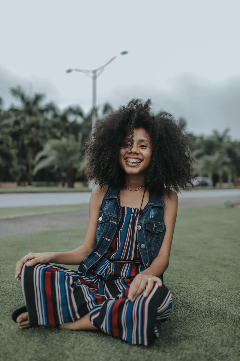 enjoyment, african, outdoors, fashion, real people, focus, lifestyles, depth of field, focus on foreground, emotion, frizzy, girl, hair, photo, day, cute