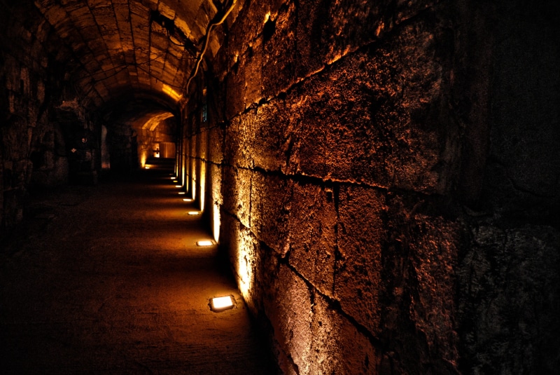 arch, historical, brick, lighting equipment, illuminated, arcade, indoors, diminishing perspective, no people, built structure, surface, rock, architecture