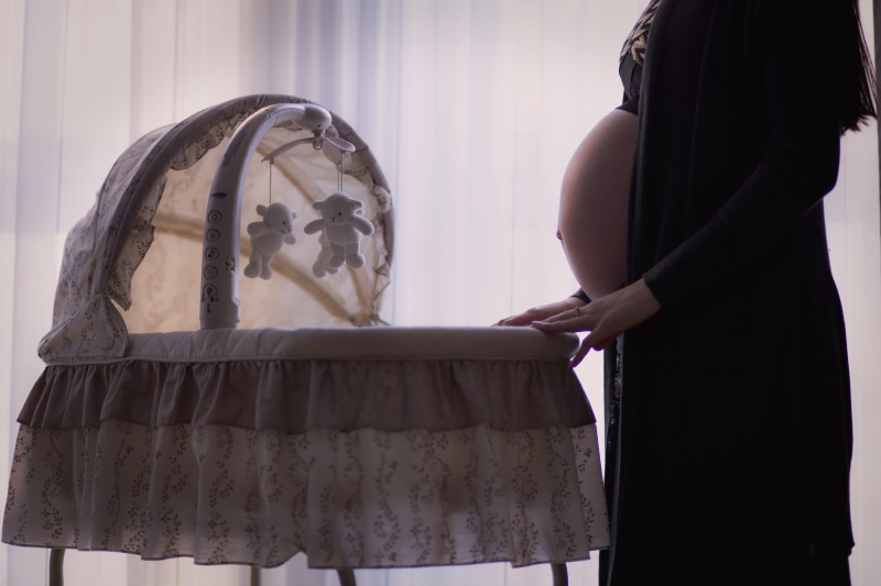 person, textile, women, human body part, art and craft, real people, indoors, bassinet, day, clothing, expecting, fashion, family, human abdomen, mother
