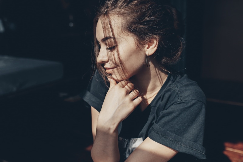 indoors, sadness, females, hoop earrings, focus on foreground, hopelessness, hairstyle, model, profile, adult, hair in face, brunette, s, lifestyles, shirt