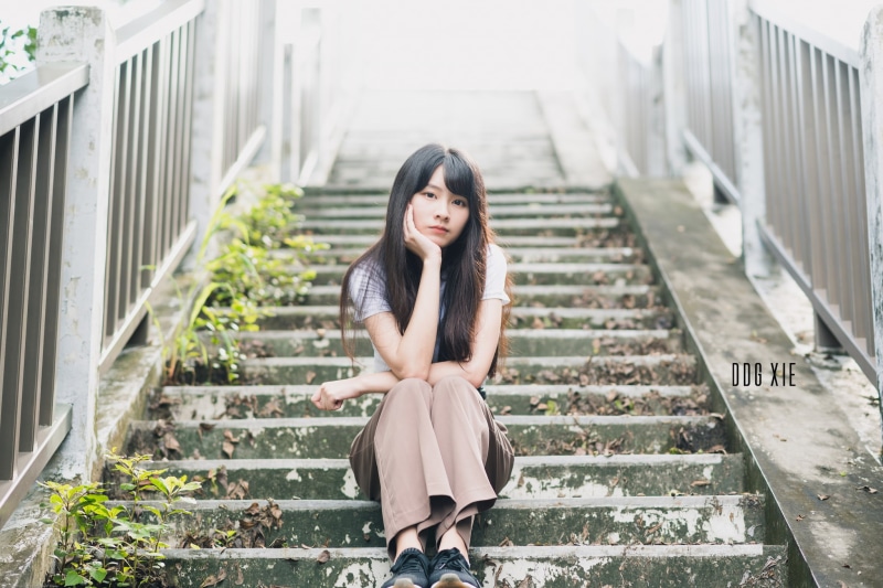 staircase, front view, looking at camera, sitting, adult, architecture, women, sadness, 1080P, teenager, brunette, one person, portrait, real people, young women
