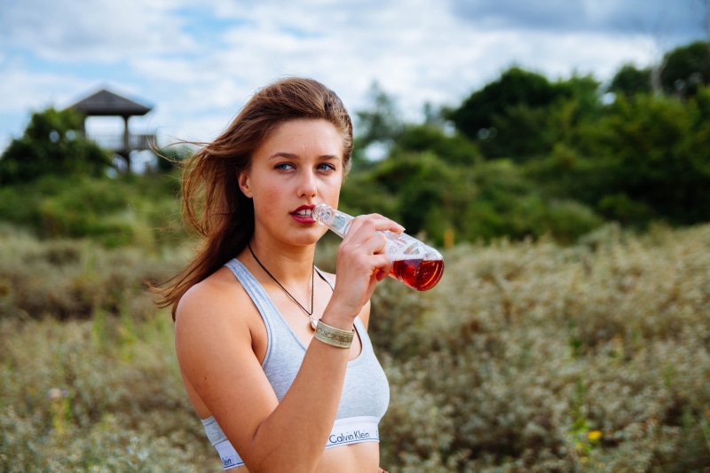 women outdoors, windy, looking away, 1080P, open mouth, brunette, Calvin Klein, women, drink, bottles