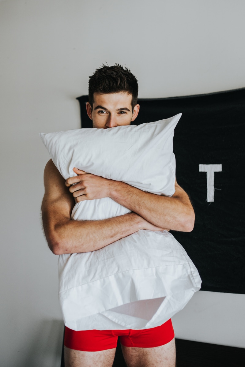 white color, bed, squeeze, cute, one person, red, 4K, young men, caucasian, atl, three quarter length, indoors, man, calvin, calvin klien, arms crossed