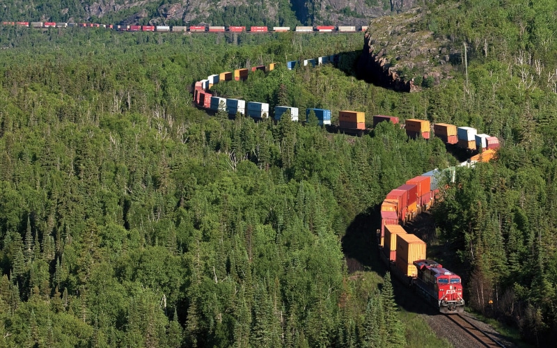 train, field, high angle view, nature, real people, environment, diesel locomotive, landscape, day, mode of transportation, scenics - nature, freight train