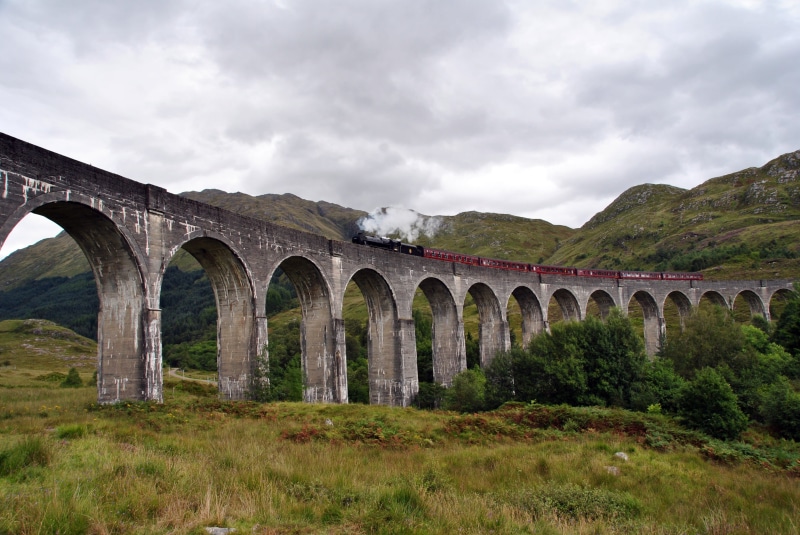 viaduct, outdoors, plant, architecture, by train, built structure, machine, rail transportation, machinist, bridge - man made structure, locomotive, transportation