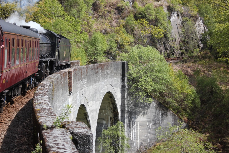 flowing water, arch bridge, motion, nature, black, water, transportation, daytime, plant, tree, arch, outdoors, running, green color, connection, 5K, jacobite steam train