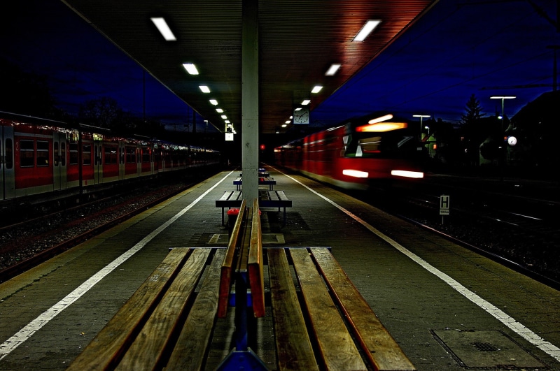 track, station, public transportation, night, railroad station, photography, mode of transportation, platform, travel, railway, lighting equipment, train - vehicle
